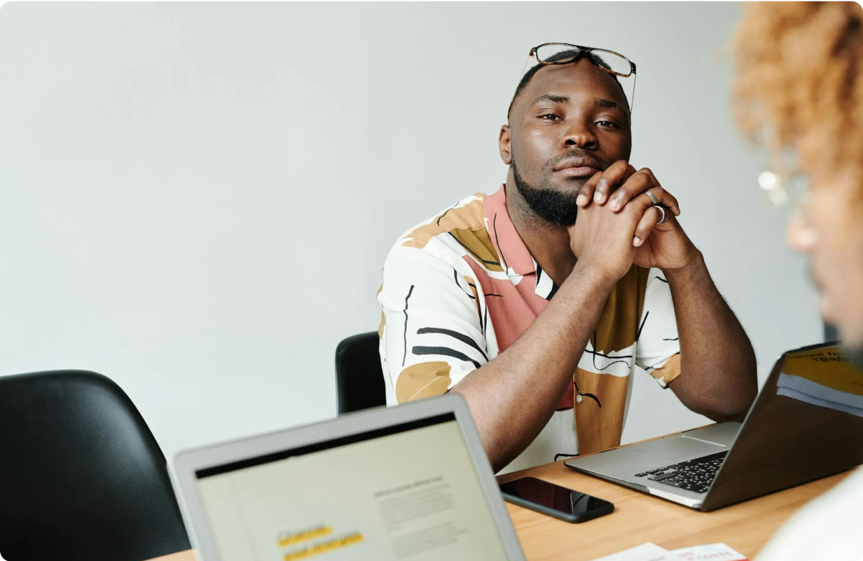 Man holding his chin in a sitting position